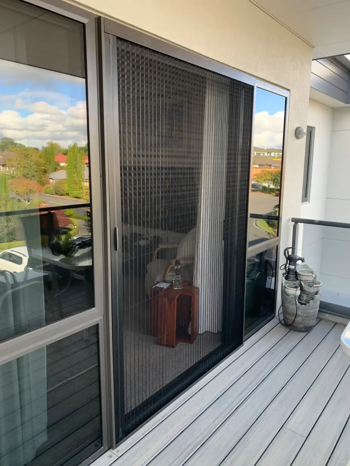 Brio folding screen on a deck slider with a Tauranga view