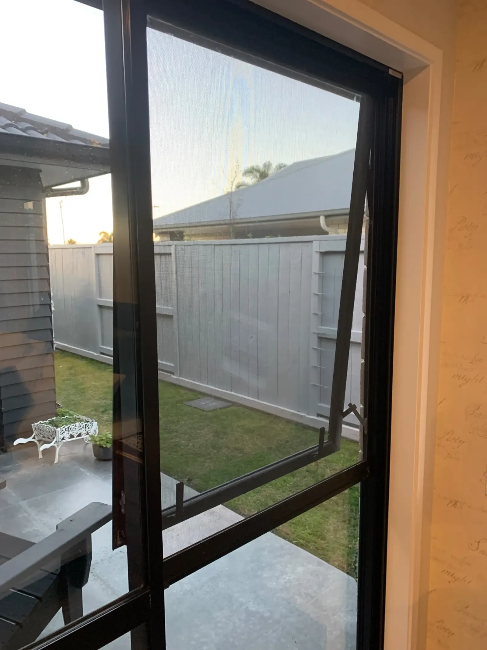Magnetic screen on a bedroom awning window at dusk, Tauranga