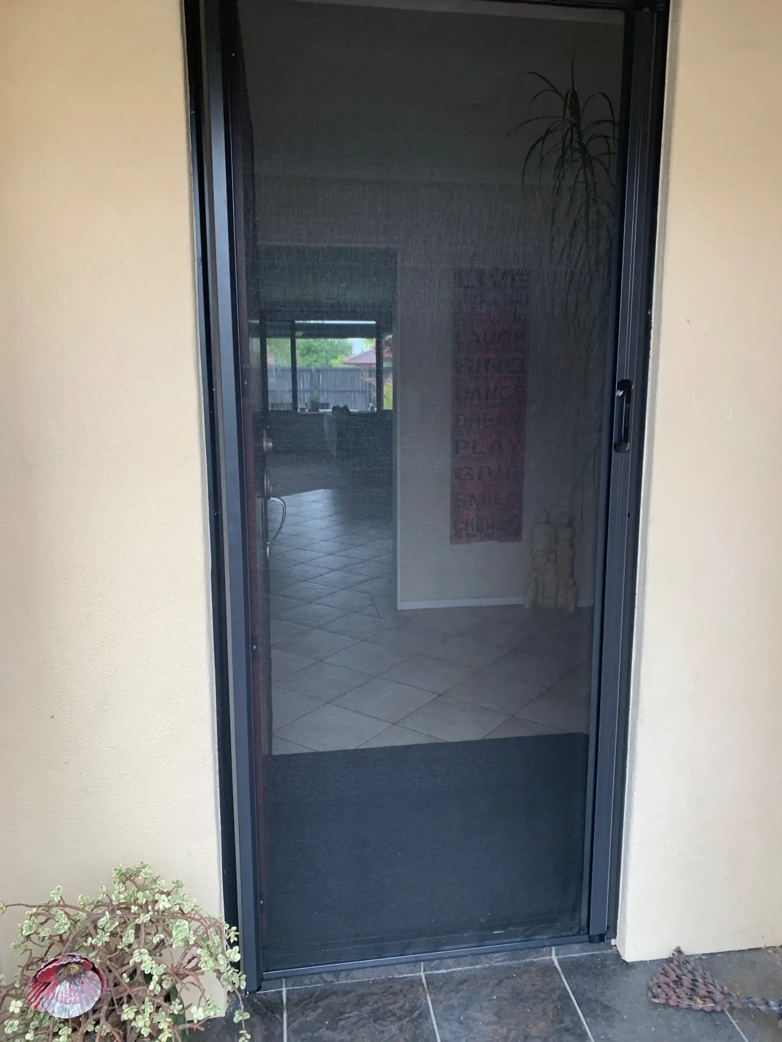 MeshLock screen drawn across a Hamilton front entry, hallway visible through the mesh
