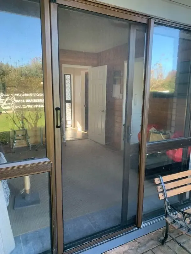 MeshLock screen across a timber-lined sunroom slider at a rural Morrinsville home