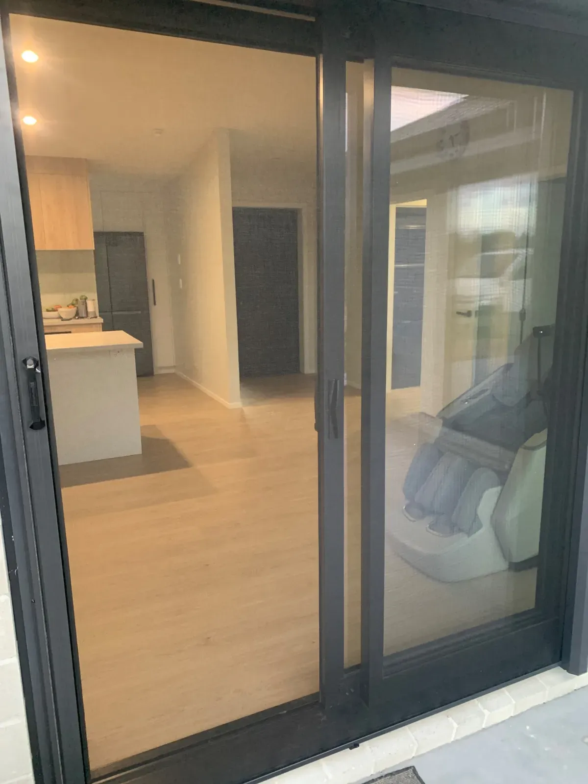 MeshLock screen across a slider into a new-build open-plan living room