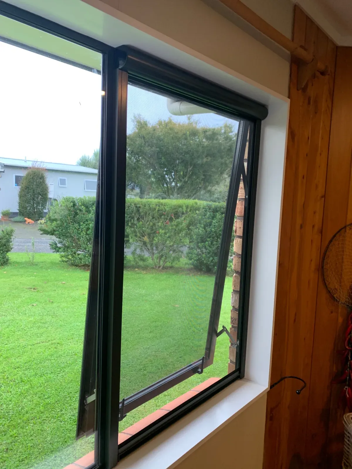 Serene screen on a lounge awning window opening to a Rotorua garden