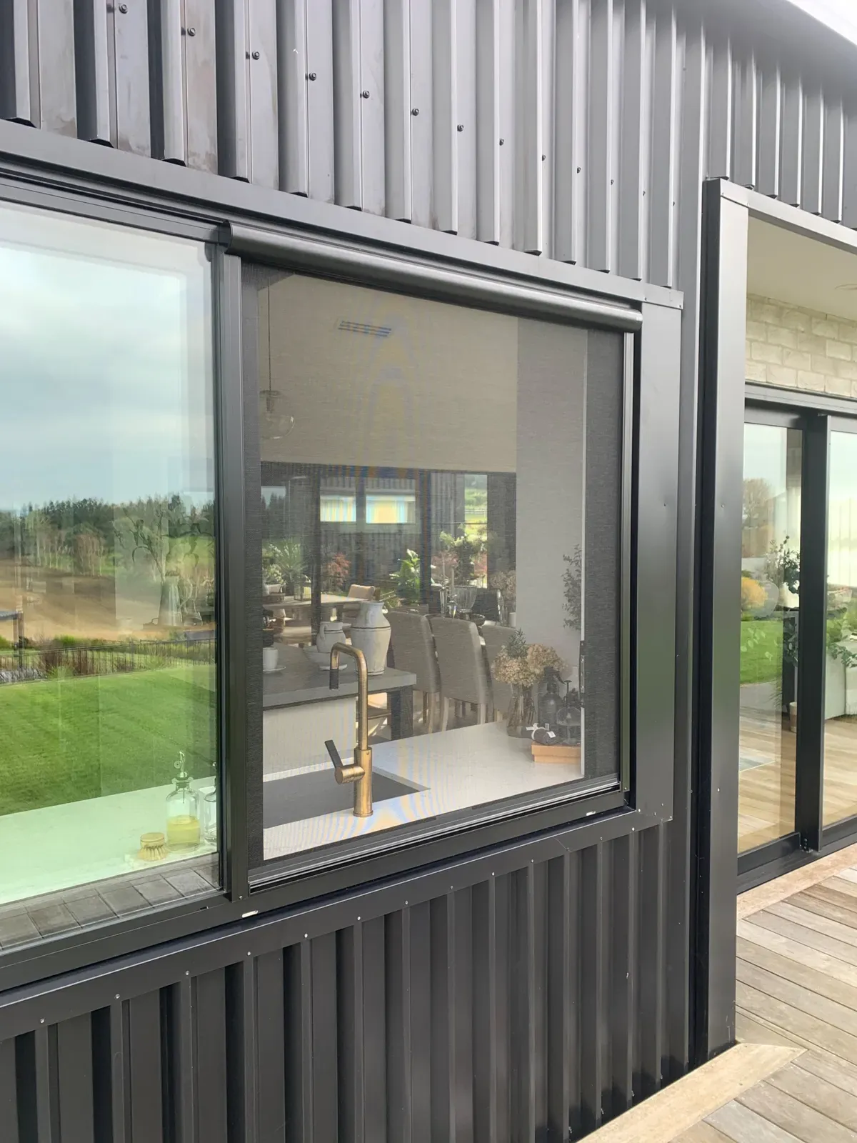 Serene screen on a large kitchen window of a dark-clad modern Te Awamutu home