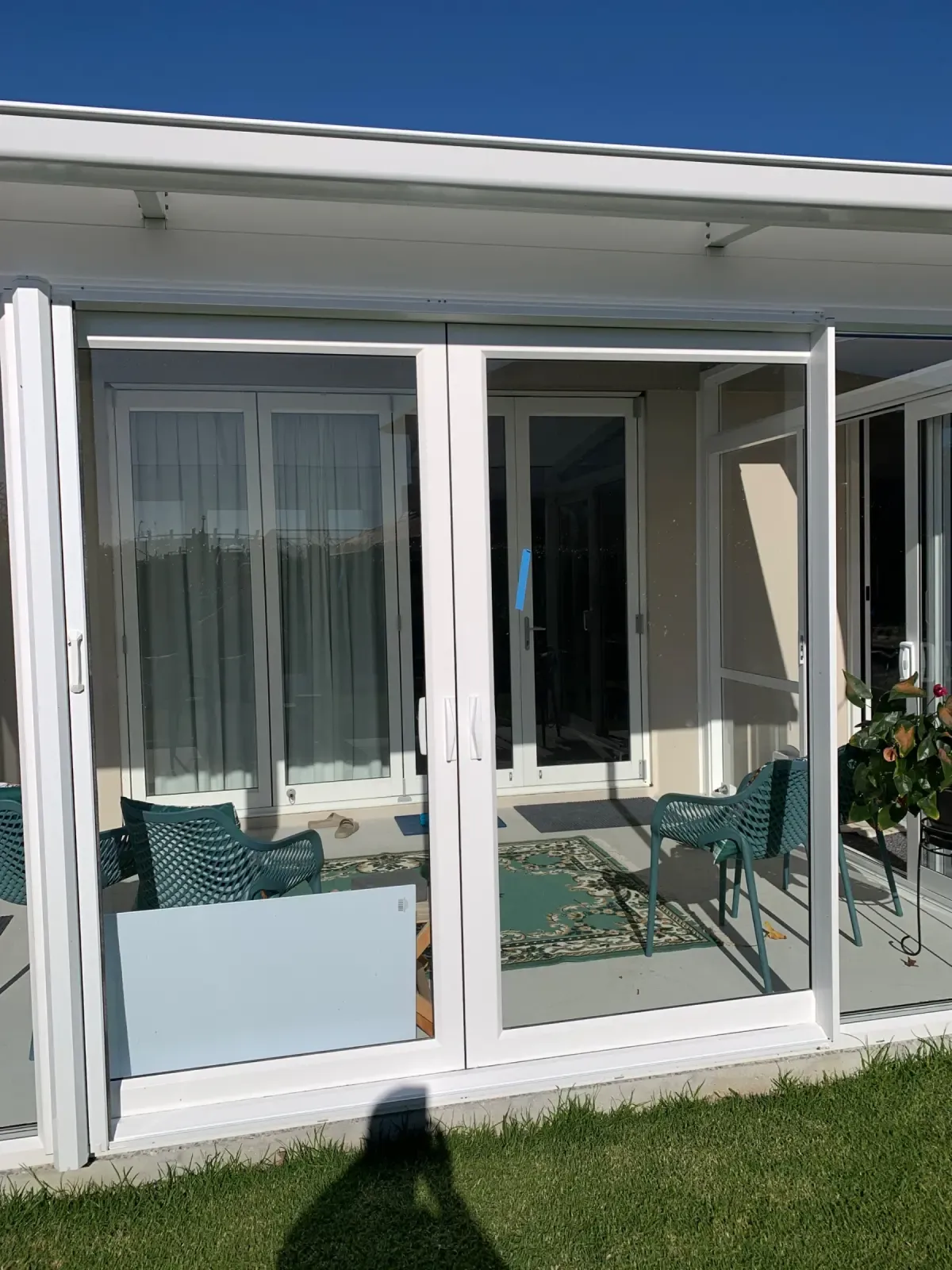 Appliance White Retractable Wall Screens across double patio doors at a pet-friendly Tauranga home
