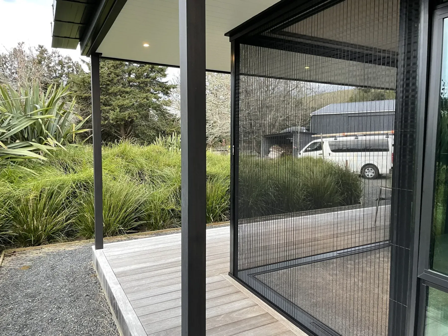 Retractable screens meeting at a corner opening with no corner post