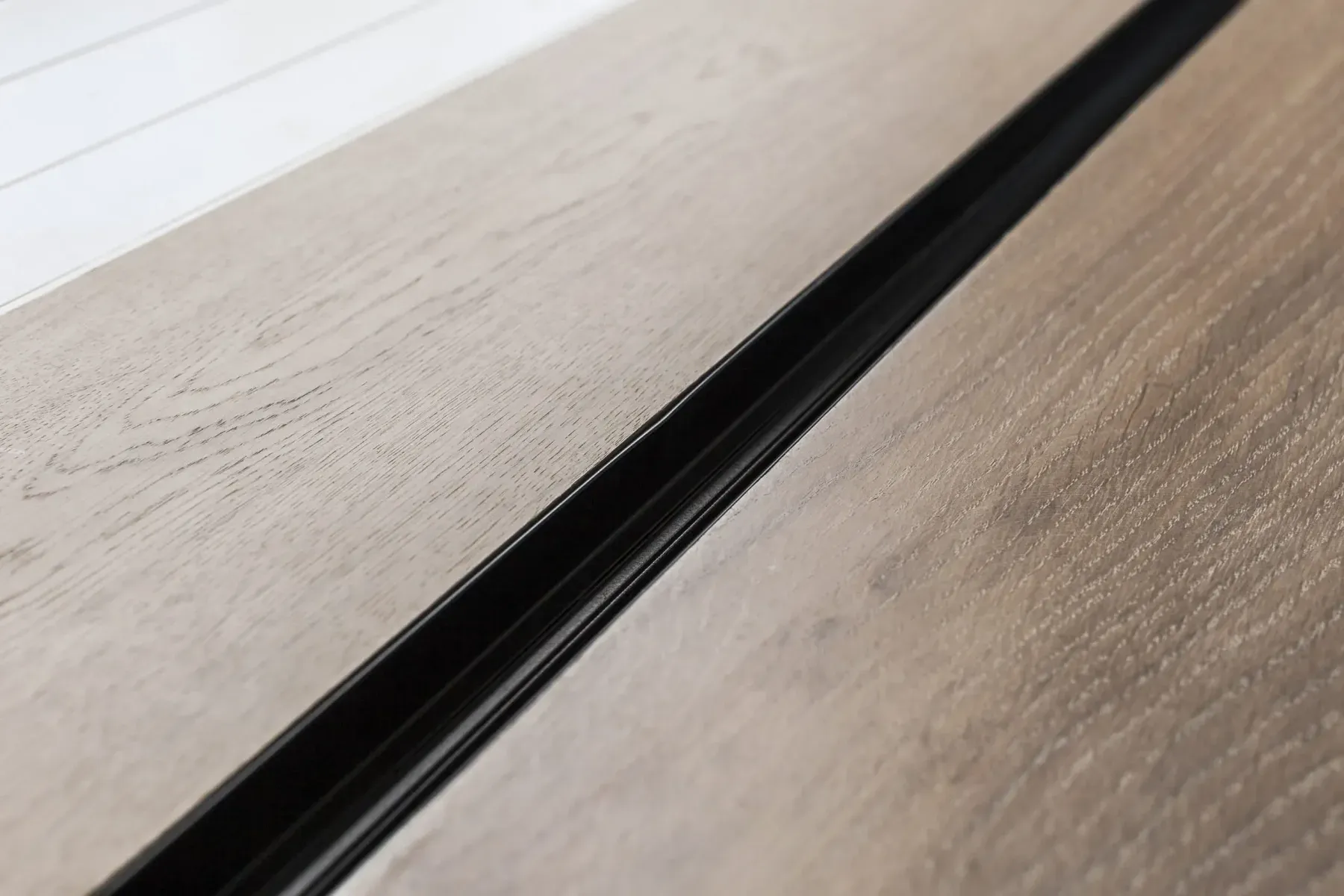 Brio 612 pleated screen track recessed flush into a timber floor