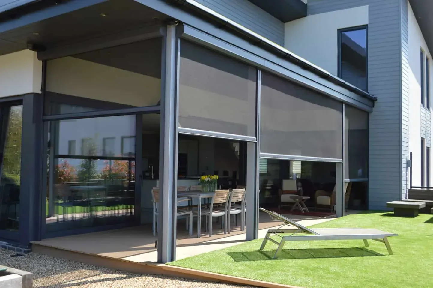 Motorised outdoor mesh blind enclosing a covered patio