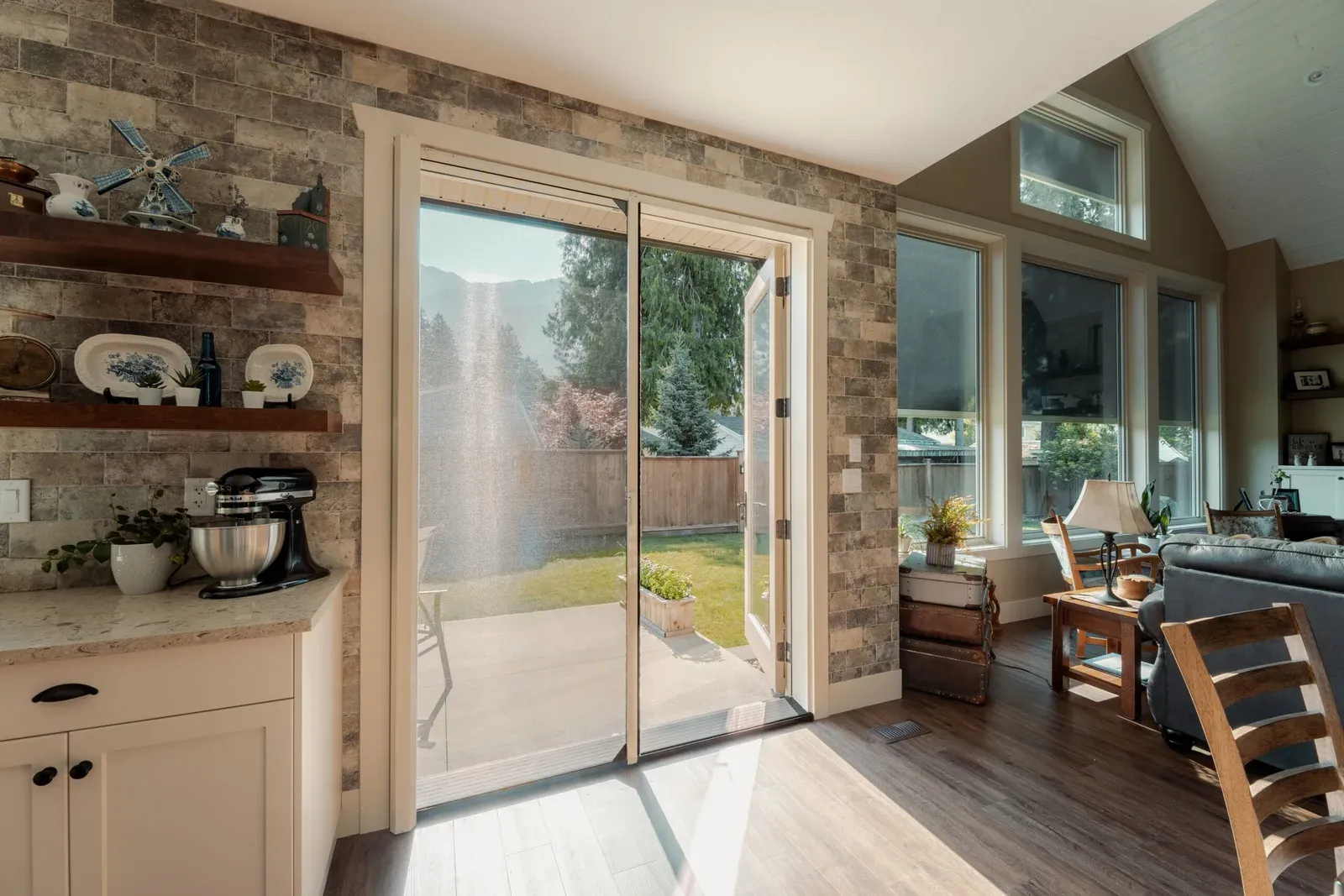 Retractable insect screen drawn across a pair of open French doors leading to a garden patio