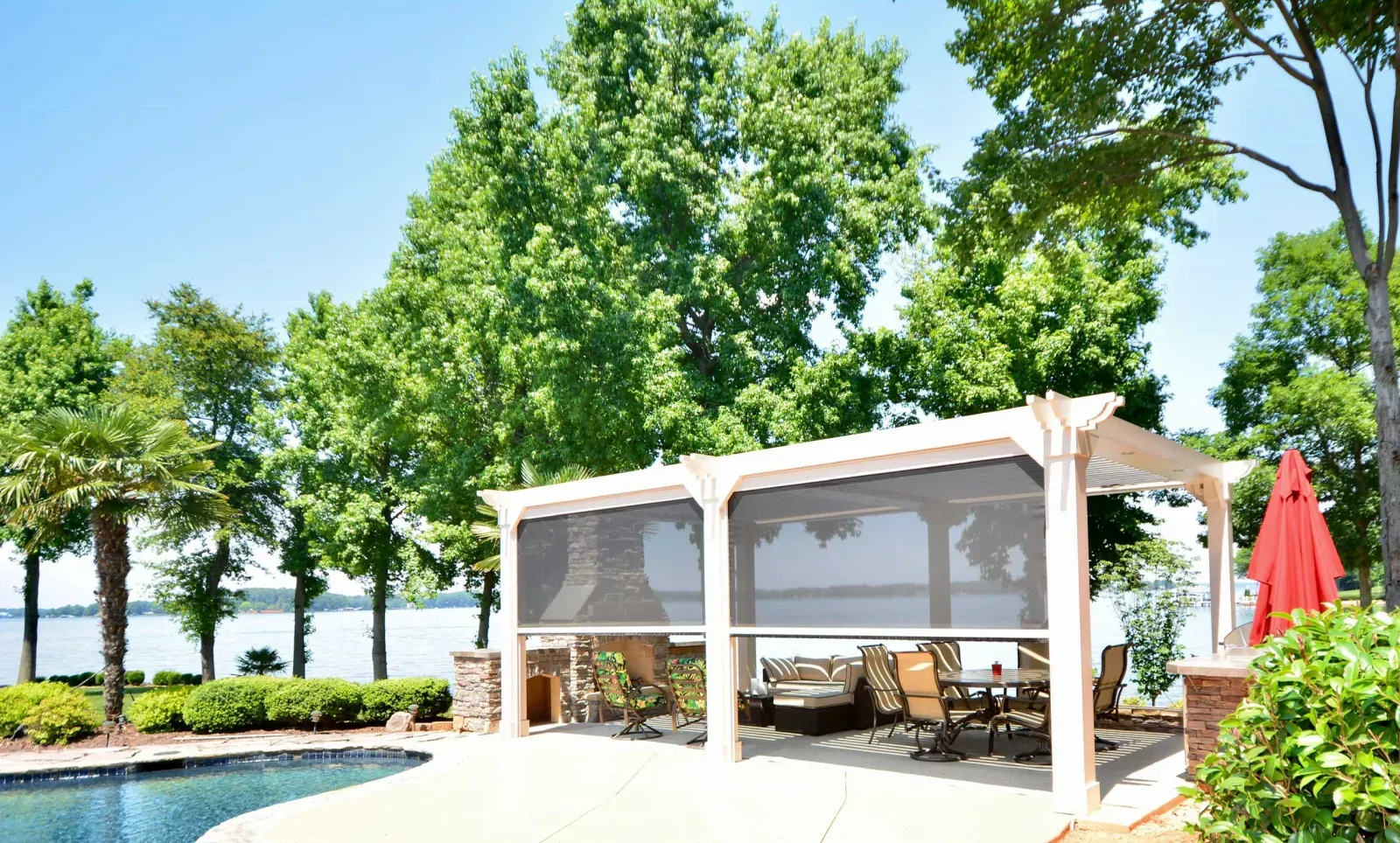 Outdoor mesh blind fitted under a pergola